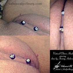 Vertical clitoris hood piercing